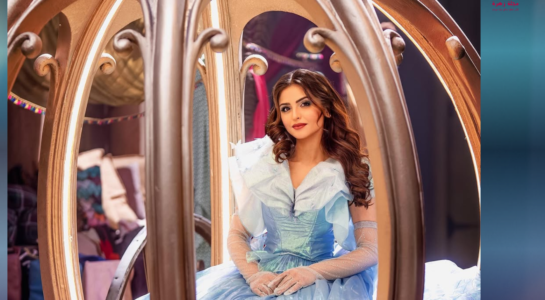 لقطة جانبية للفنانة حلا الترك بفستان أزرق سماوي منفوش مع قفازات طويلة لامعة في أجواء خيالية.